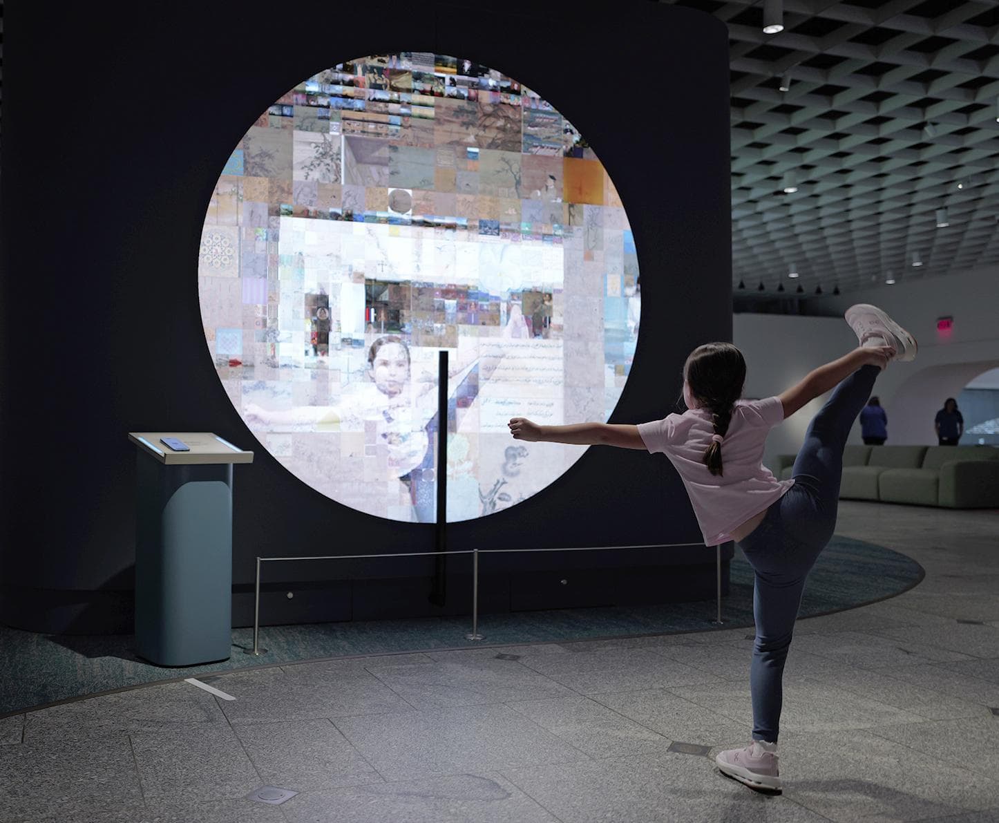 a person doing a handstand in front of a large screen
