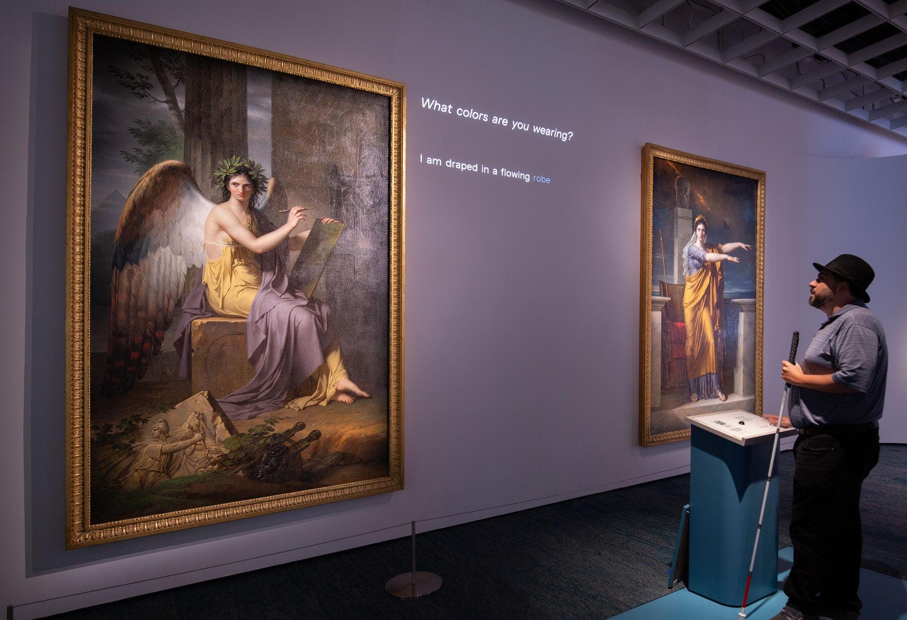a man standing next to a painting