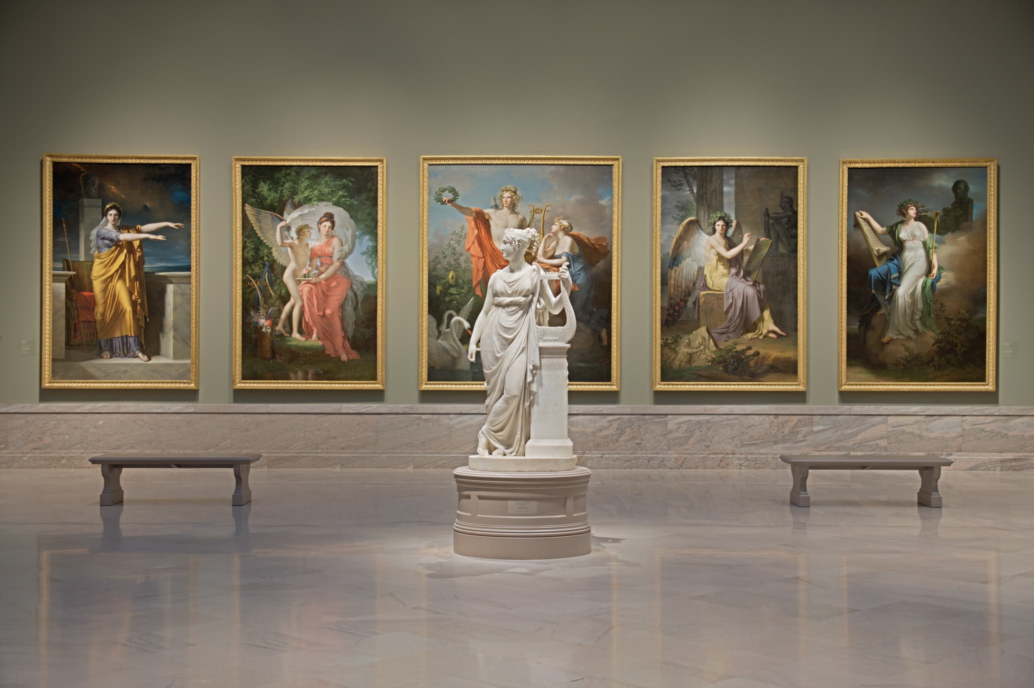 museum gallery with 5 large paintings of figures and a standing marble statue