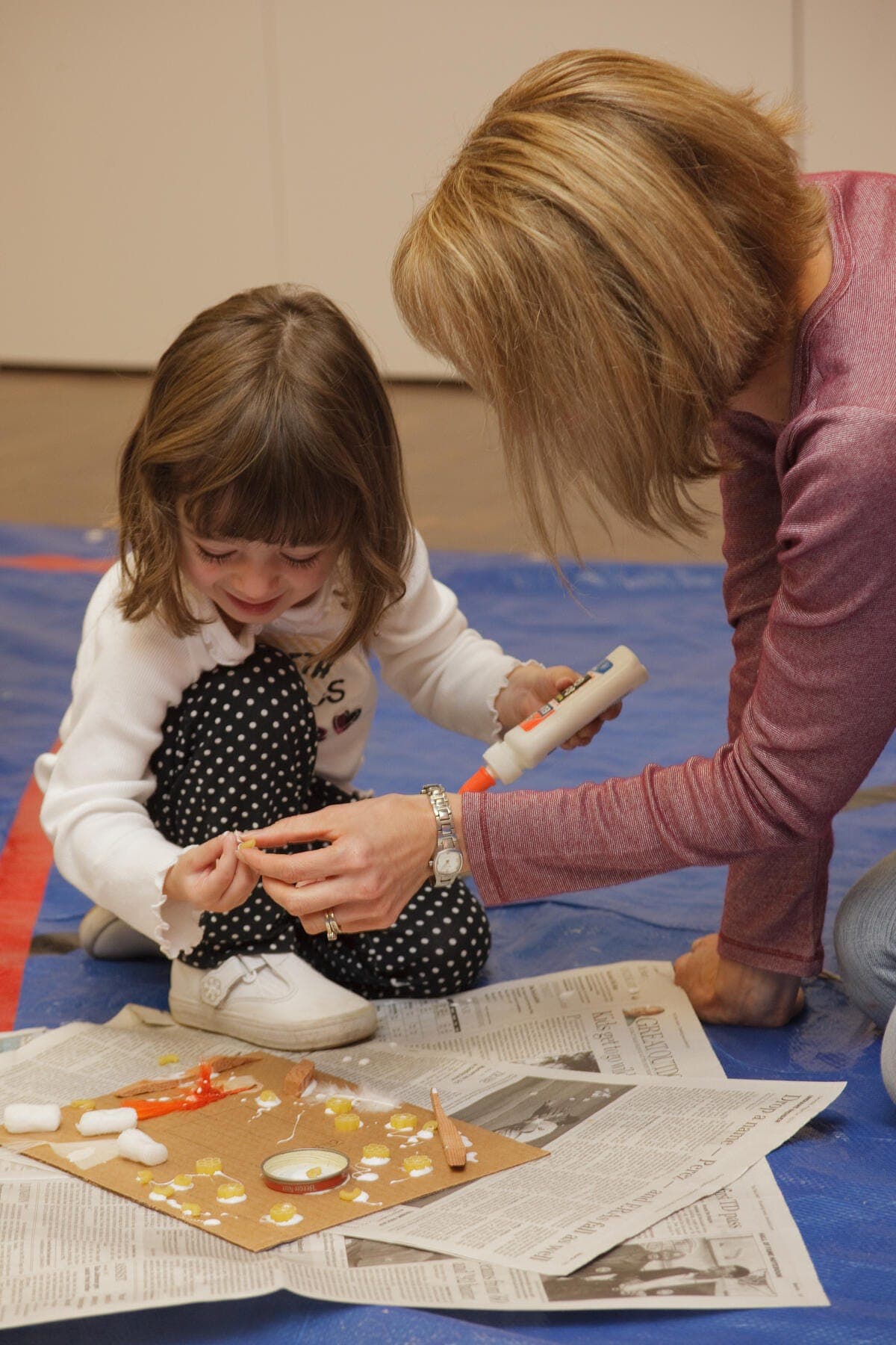 a woman and a child looking at a book