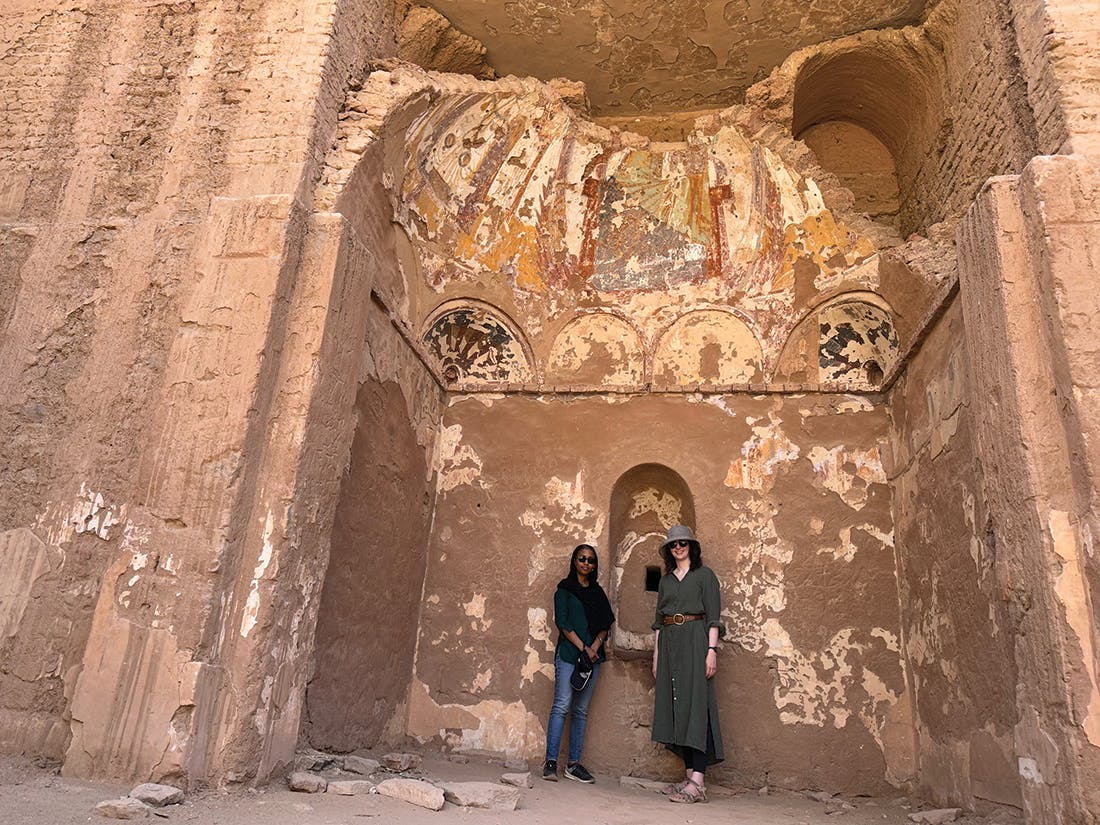 Two women in front of ancient building