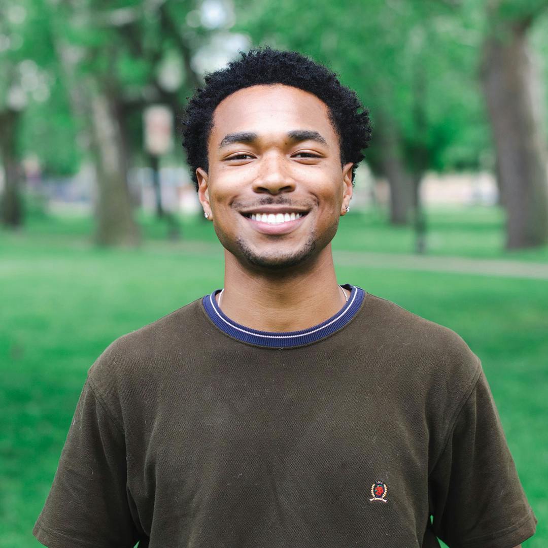 Young man smiling in park