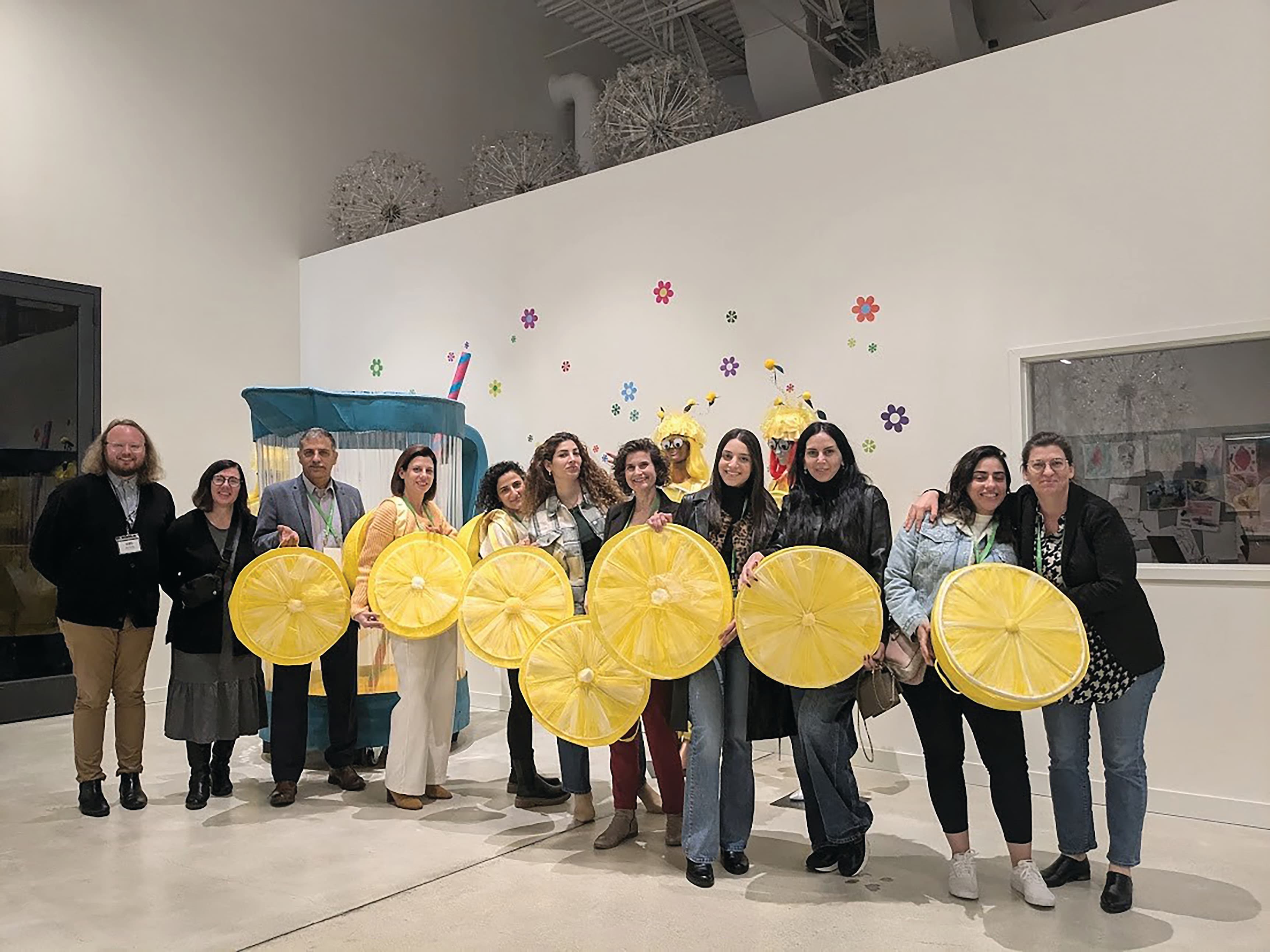 group of people holding gold circles