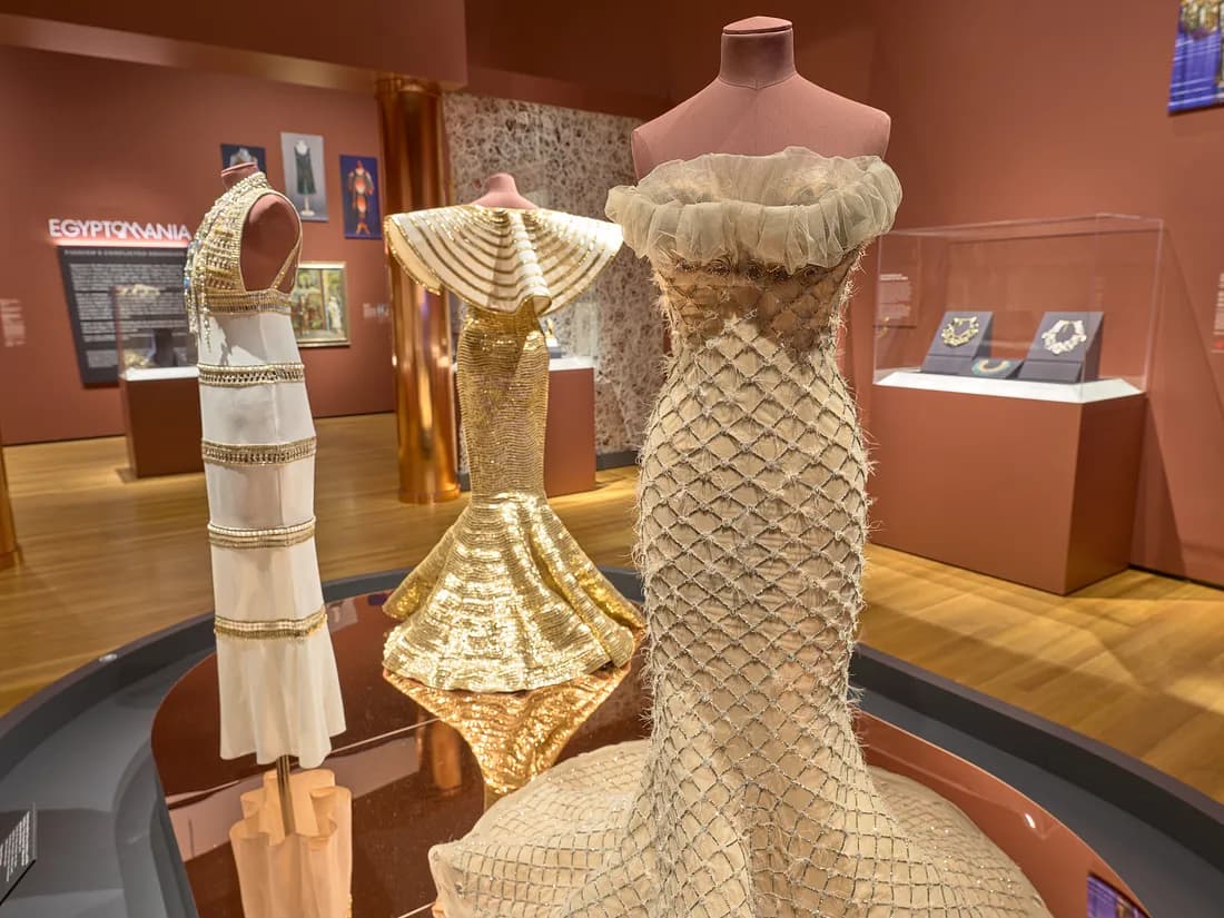 Three gold egyptian inspired dresses