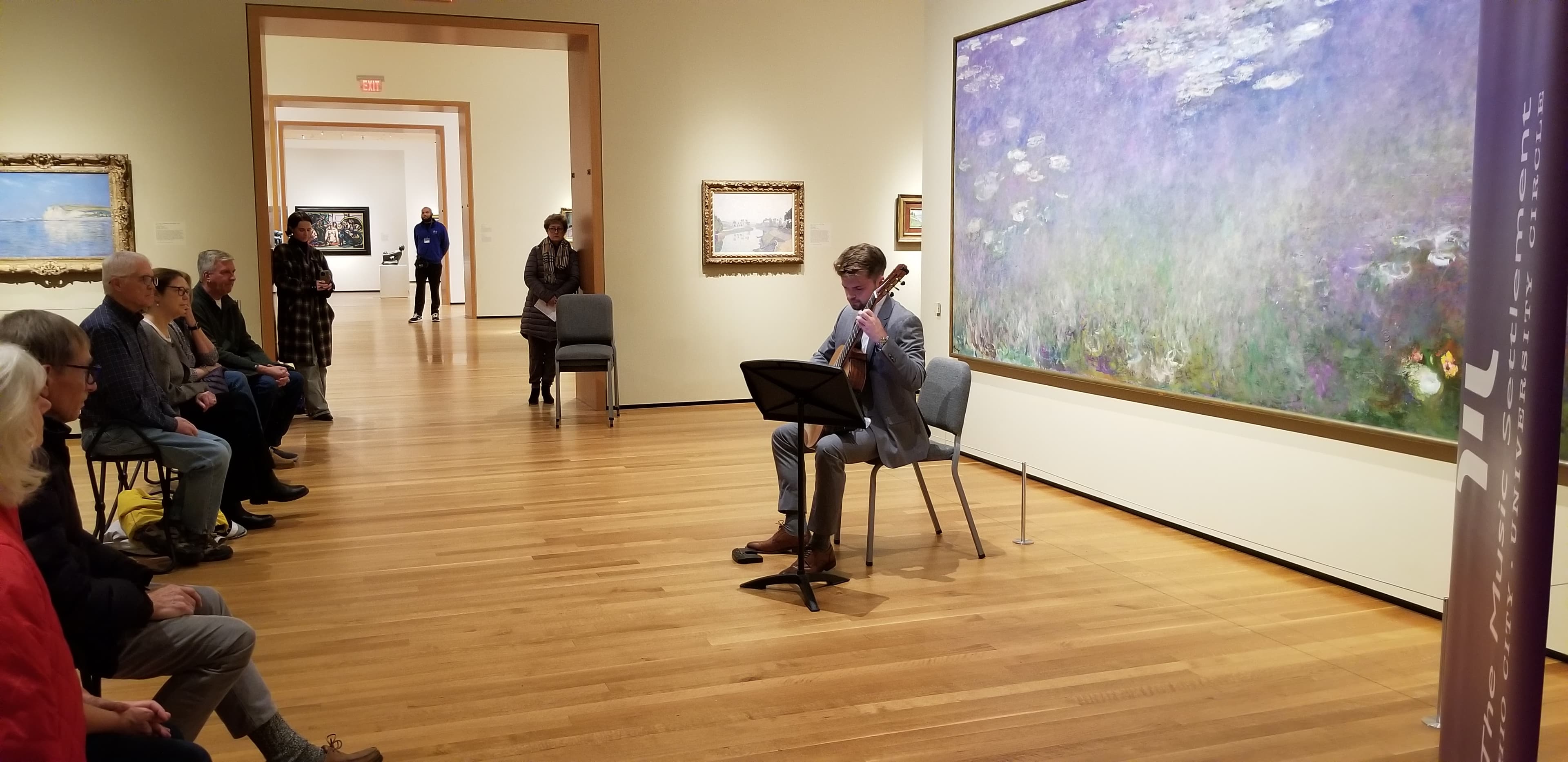 Guitar player playing in gallery