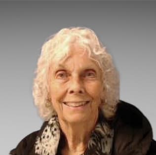 Headshot image of a woman with white hair