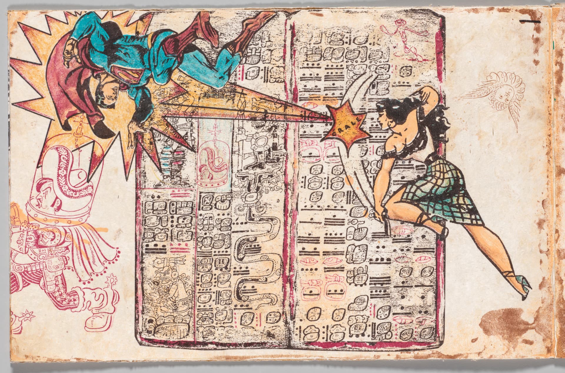 A panel from an accordion-folded book depicts comic book-style icons engaging in a fight with a Mayan codex as the background.