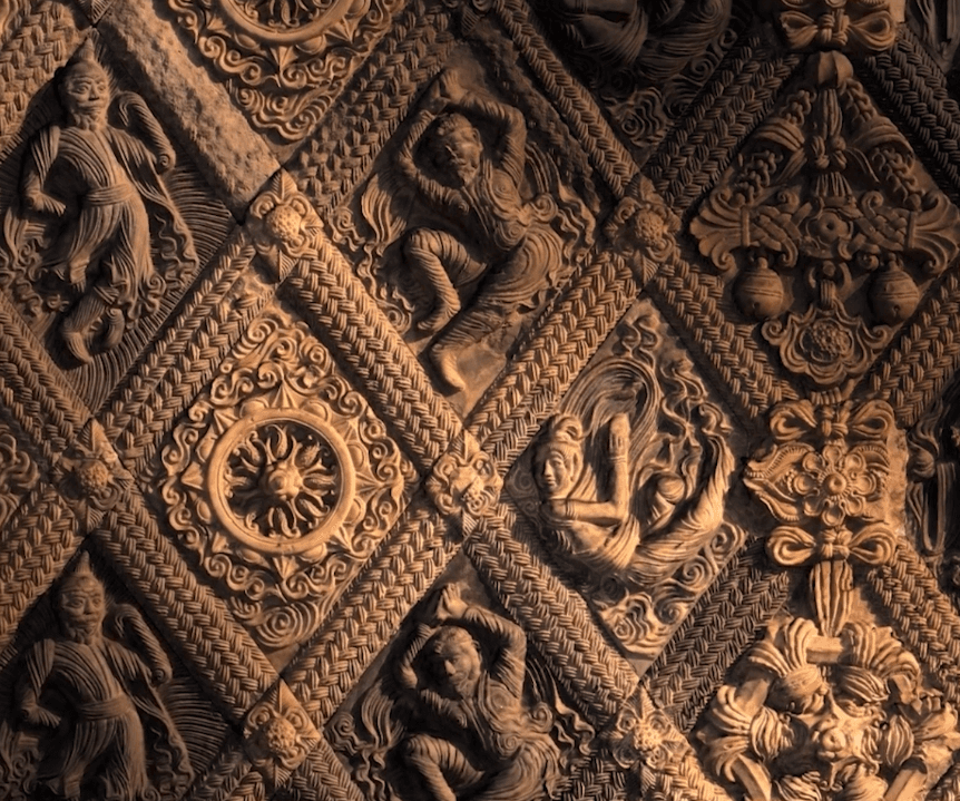 A digital 3D rendering of an ornate terracotta wall with diamond tiles containing Buddhist motifs and a variety of figures