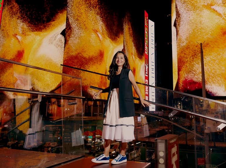 artist standing in front of her digital art