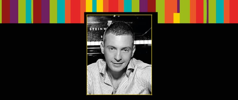 Black and white photograph of Daniel Gortler, with colorful striped border