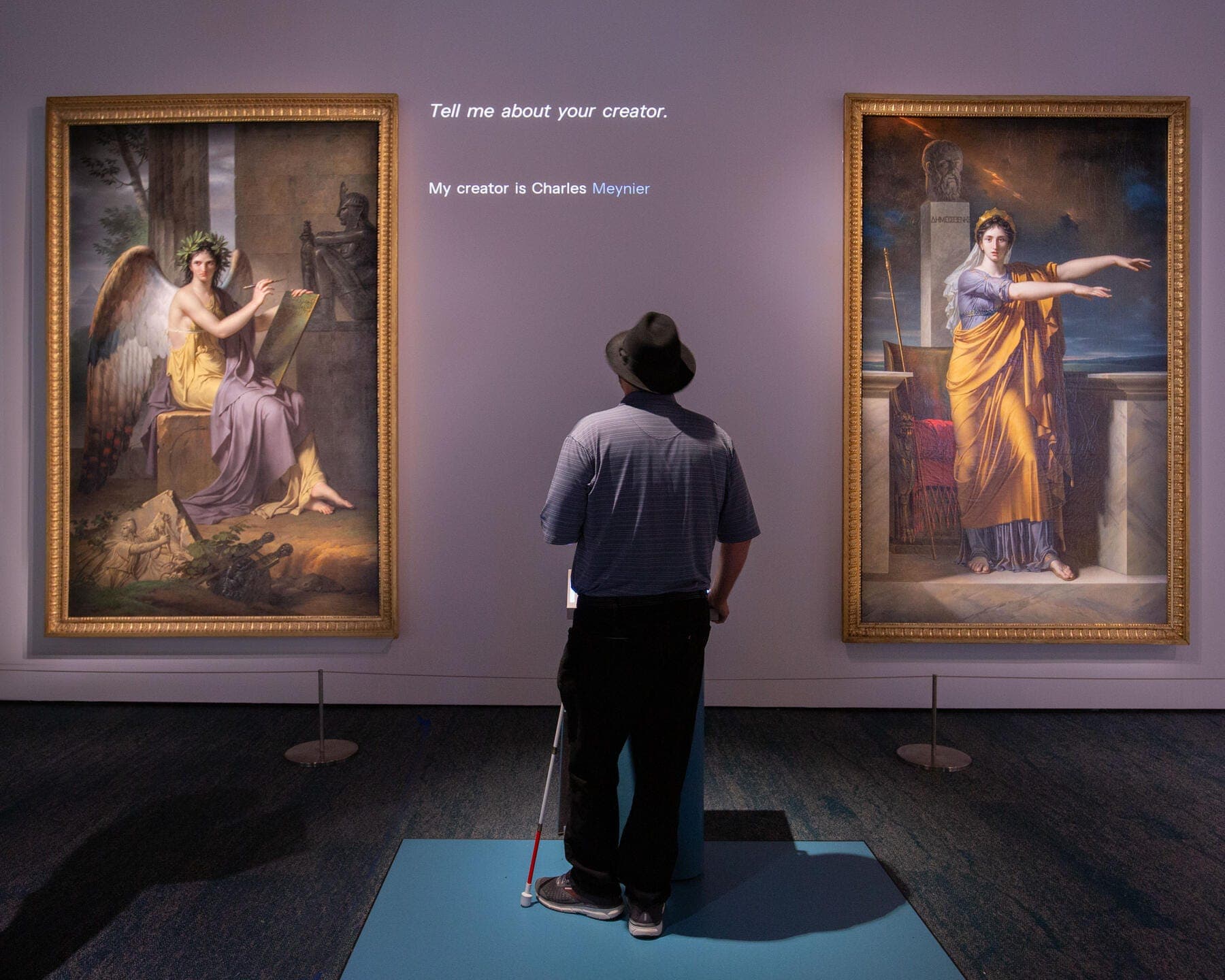 a person looking at art on the wall