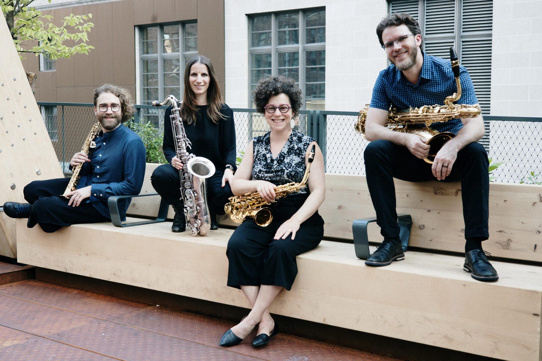 Erin Rogers et al. sitting on a porch playing instruments