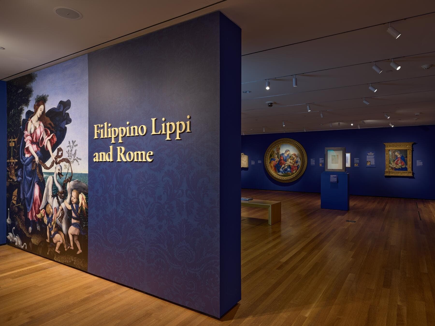 a group of people looking at a painting in a museum