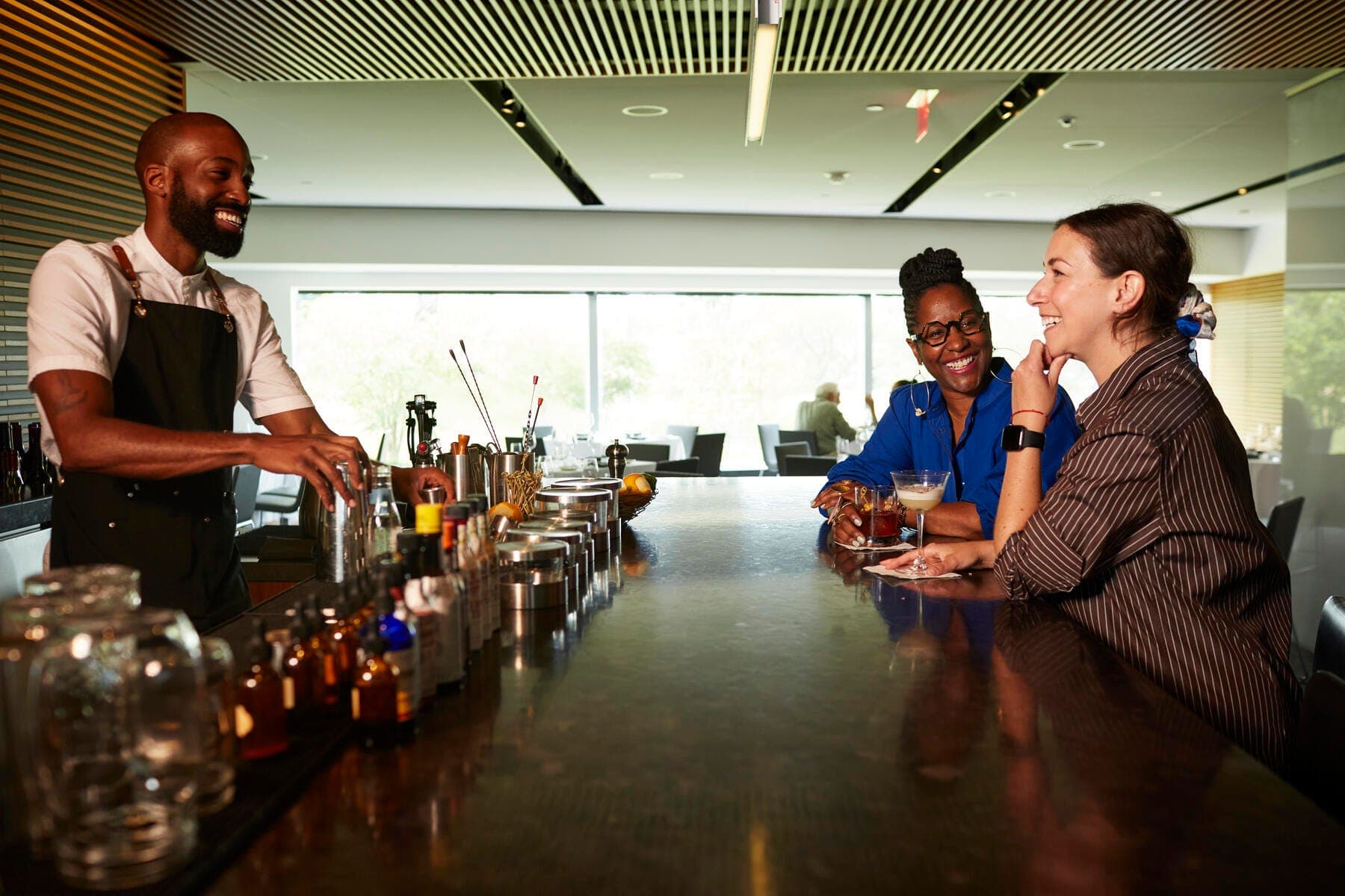 a group of people sitting at a bar