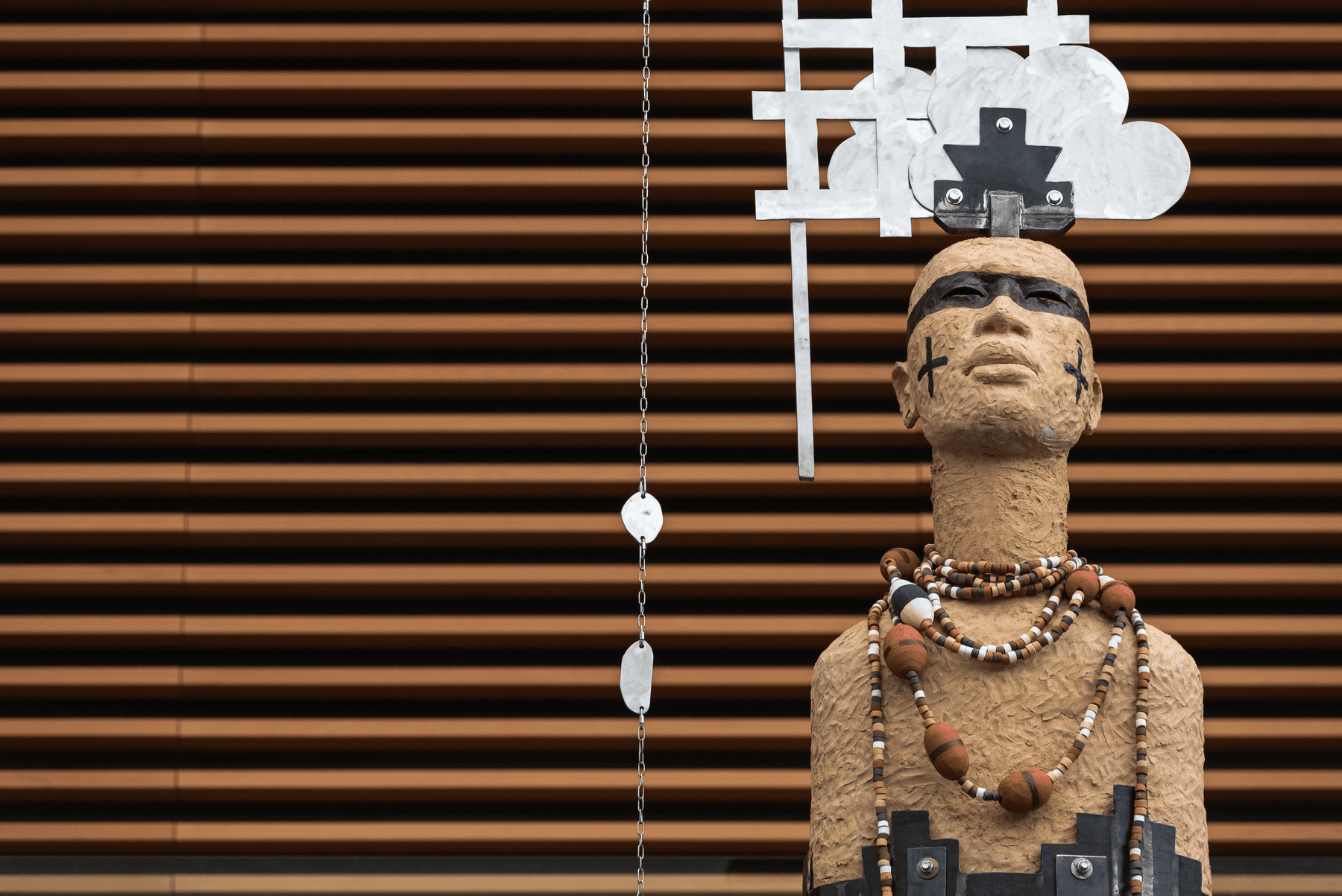 a statue of a person with a cross on the head