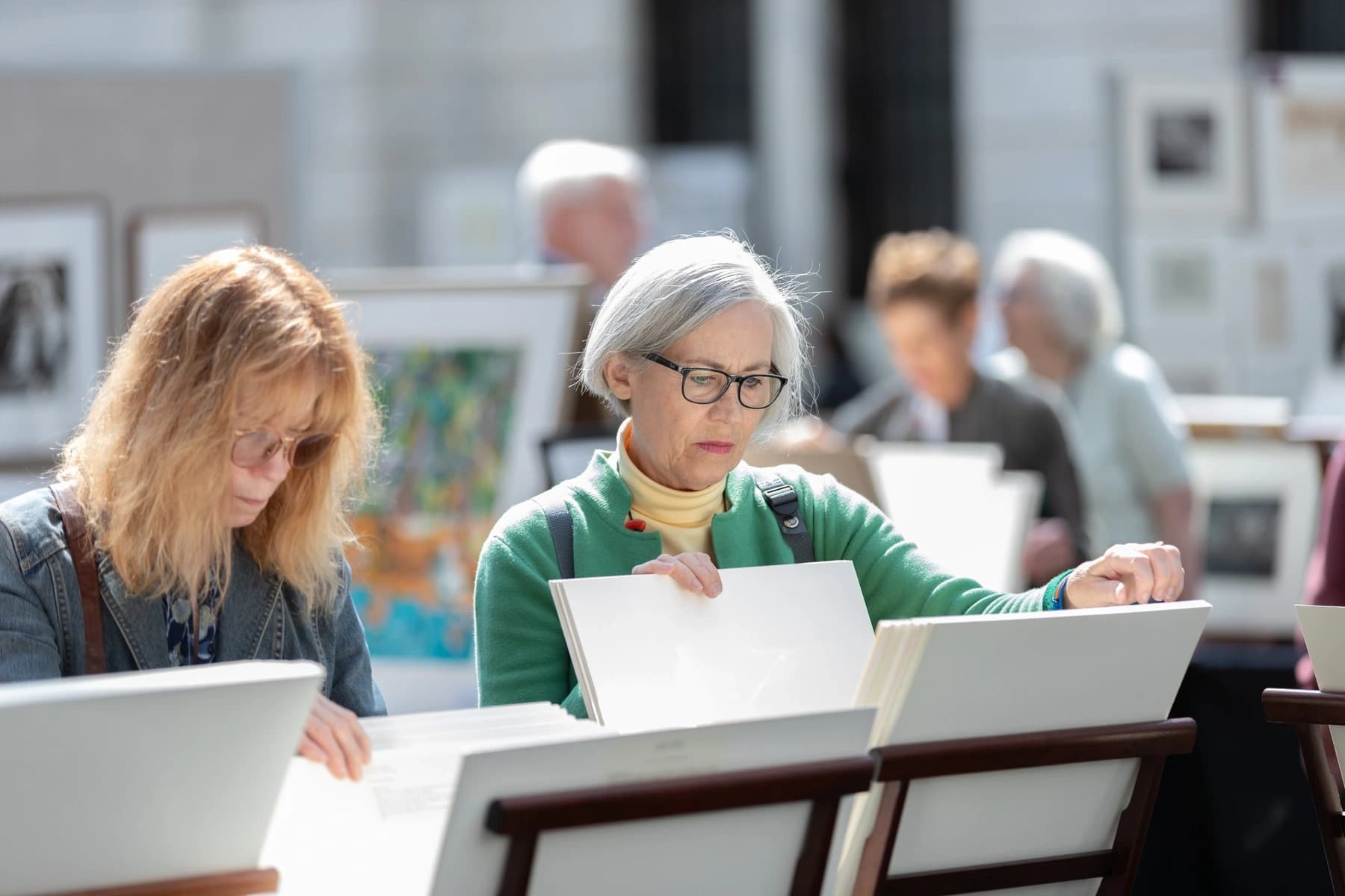 a woman and a man looking at a paper