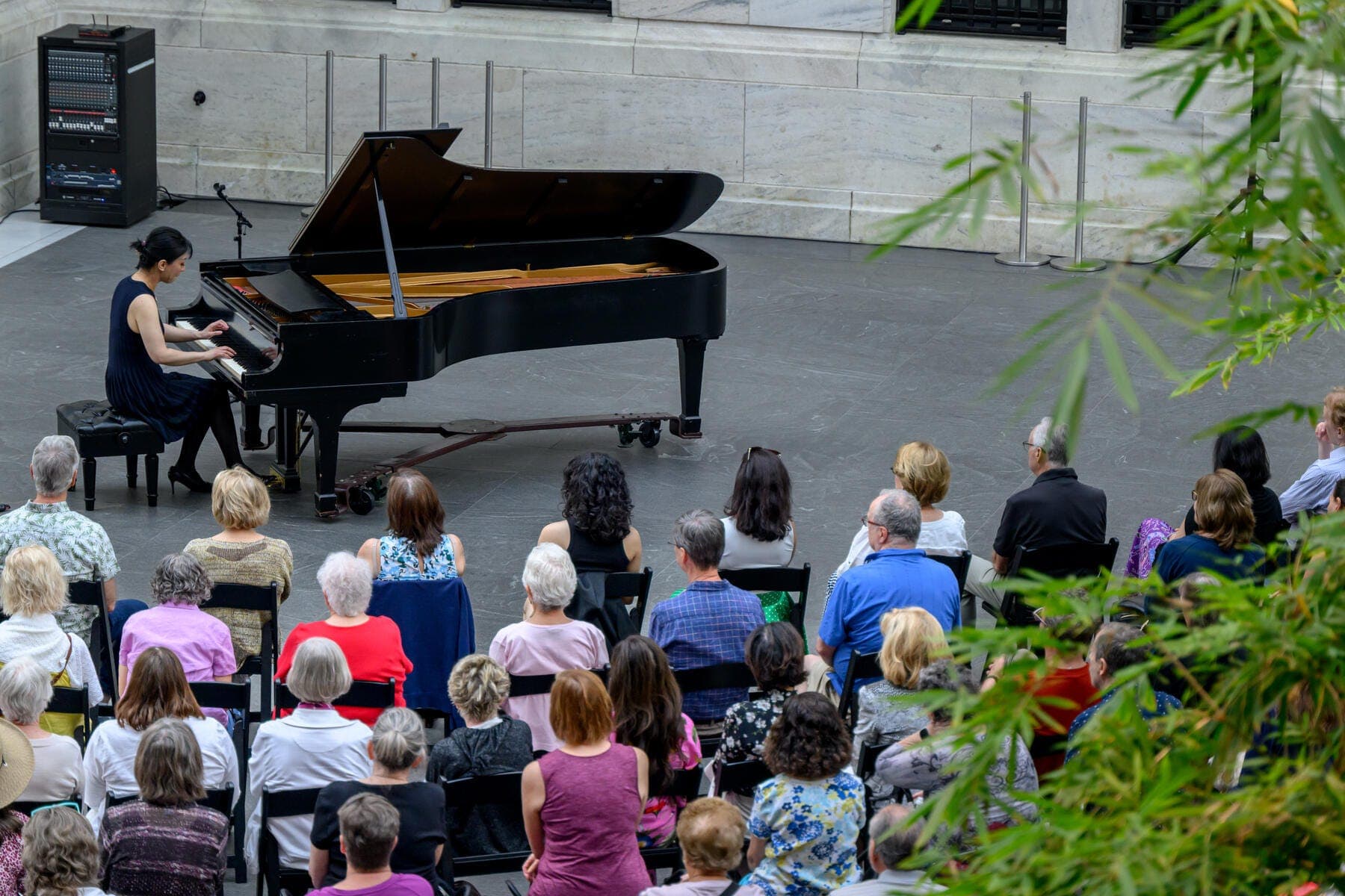 a group of people sitting in front of a piano