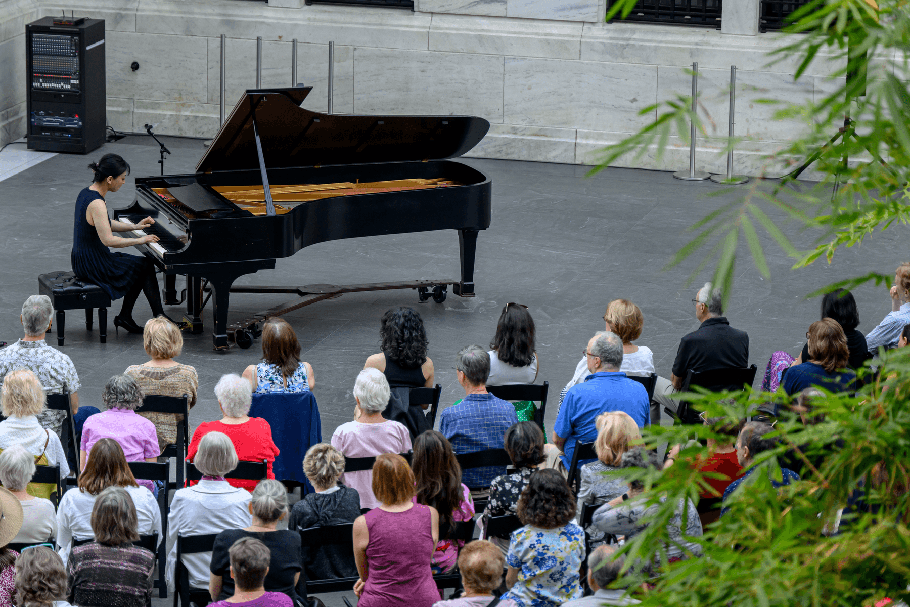 a group of people sitting in front of a piano