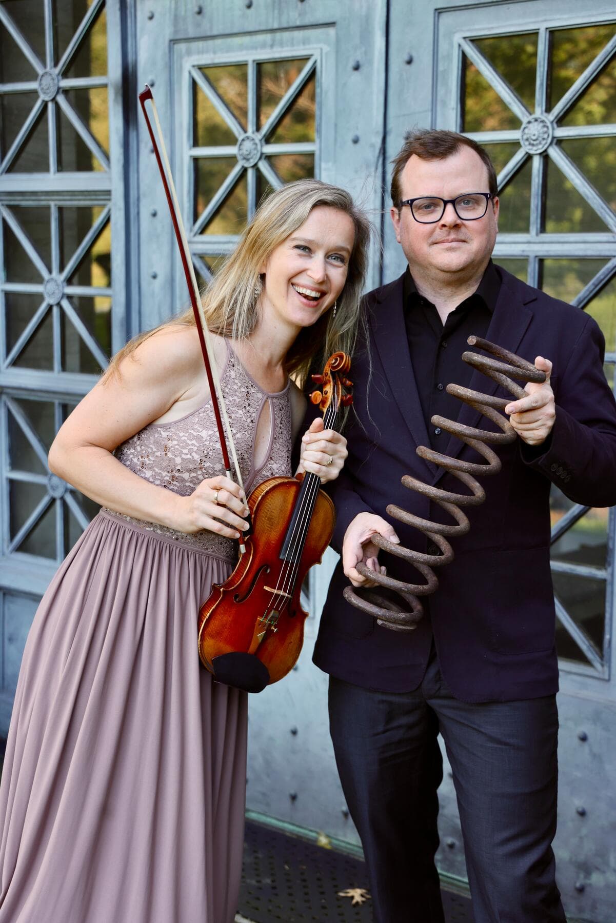 a man and woman holding a guitar