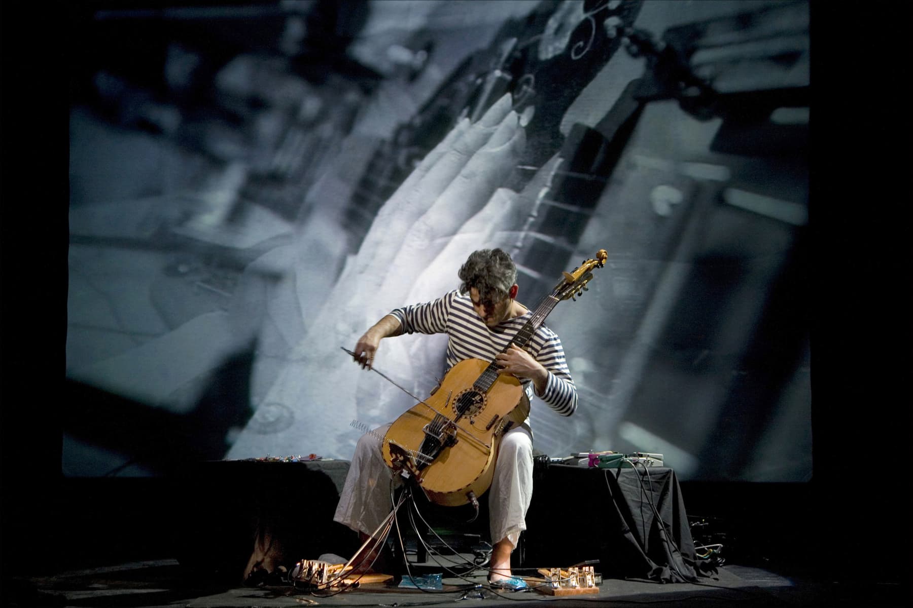a person playing a guitar on a stage