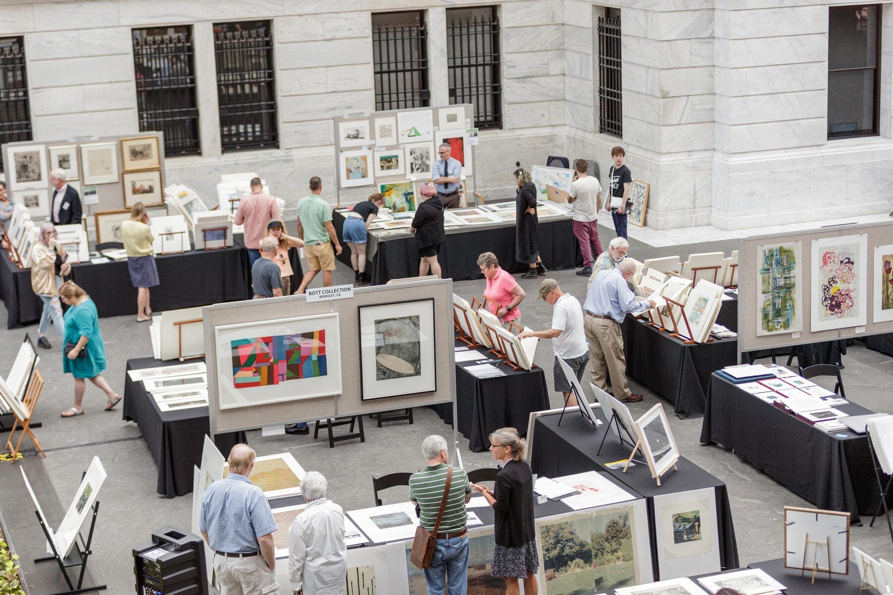 a group of people looking at a display of art