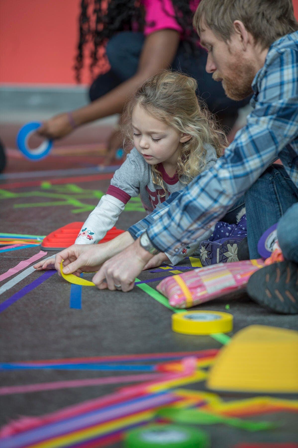 a man and a child playing with a toy