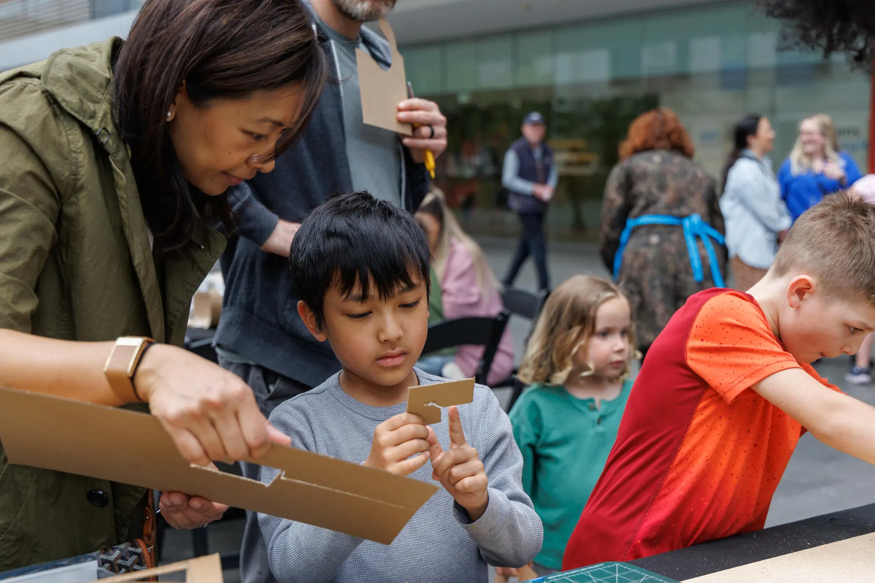 a person showing a boy something on a cell phone