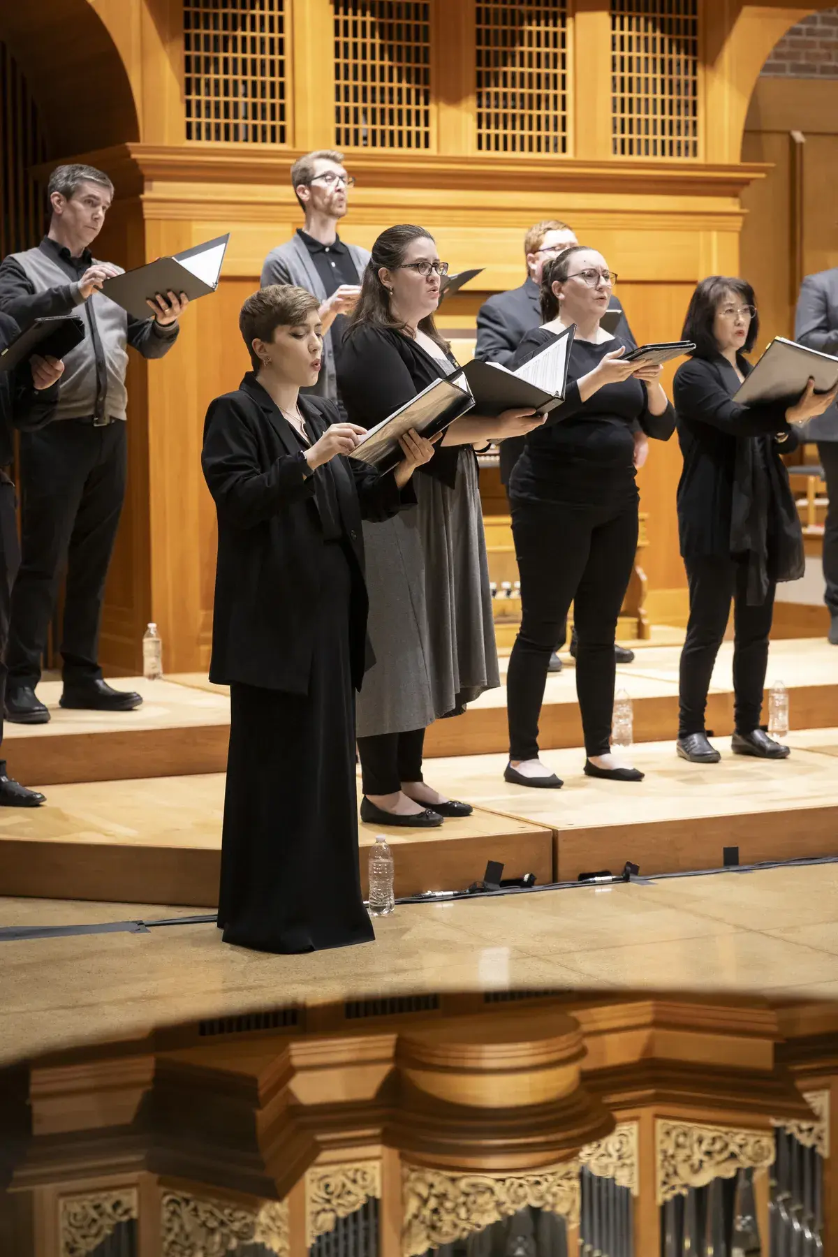 a group of people in robes and caps standing on a stage