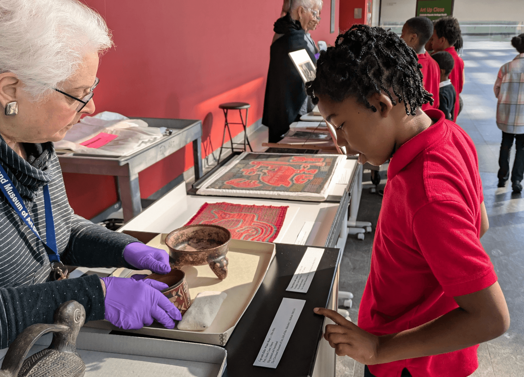 a person showing a person something on a display