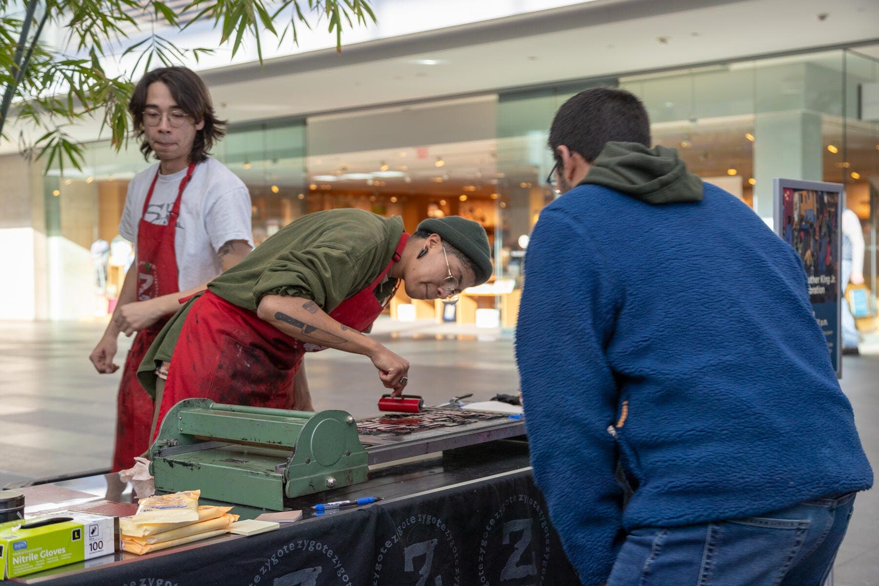 a group of people standing around a table with food on it
