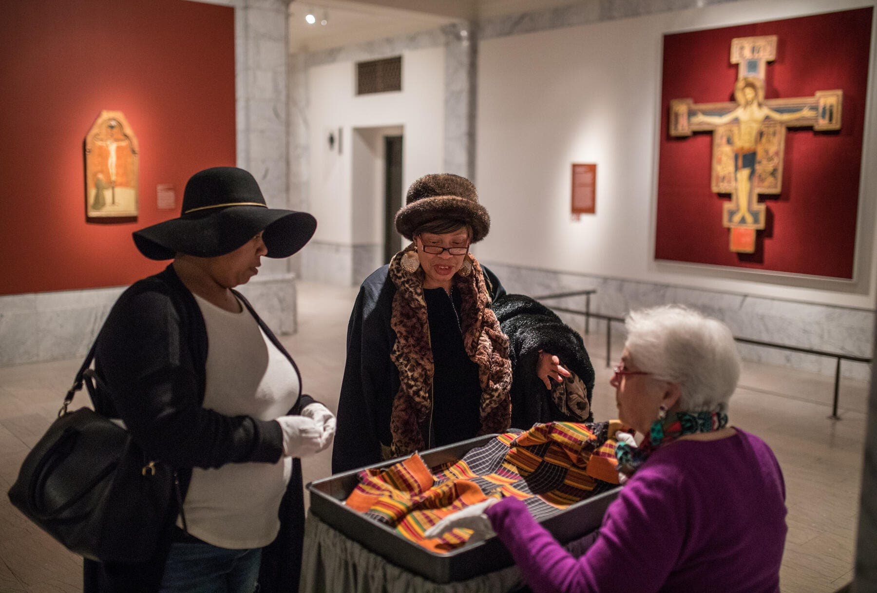 a group of people standing around a table with food on it