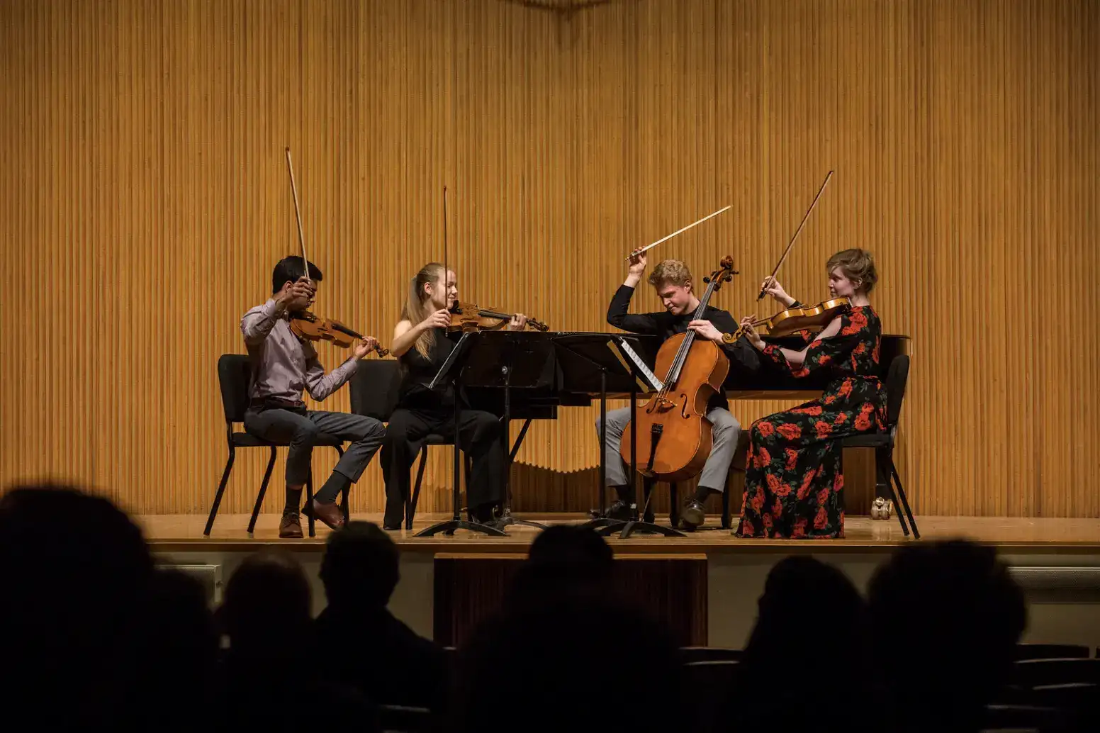 a group of people playing instruments on a stage