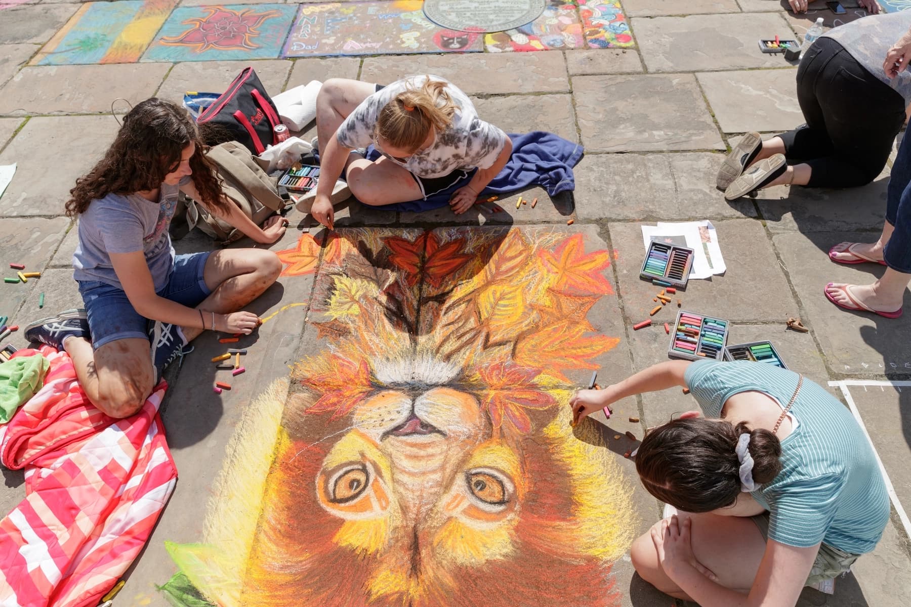 a group of people painting on the ground