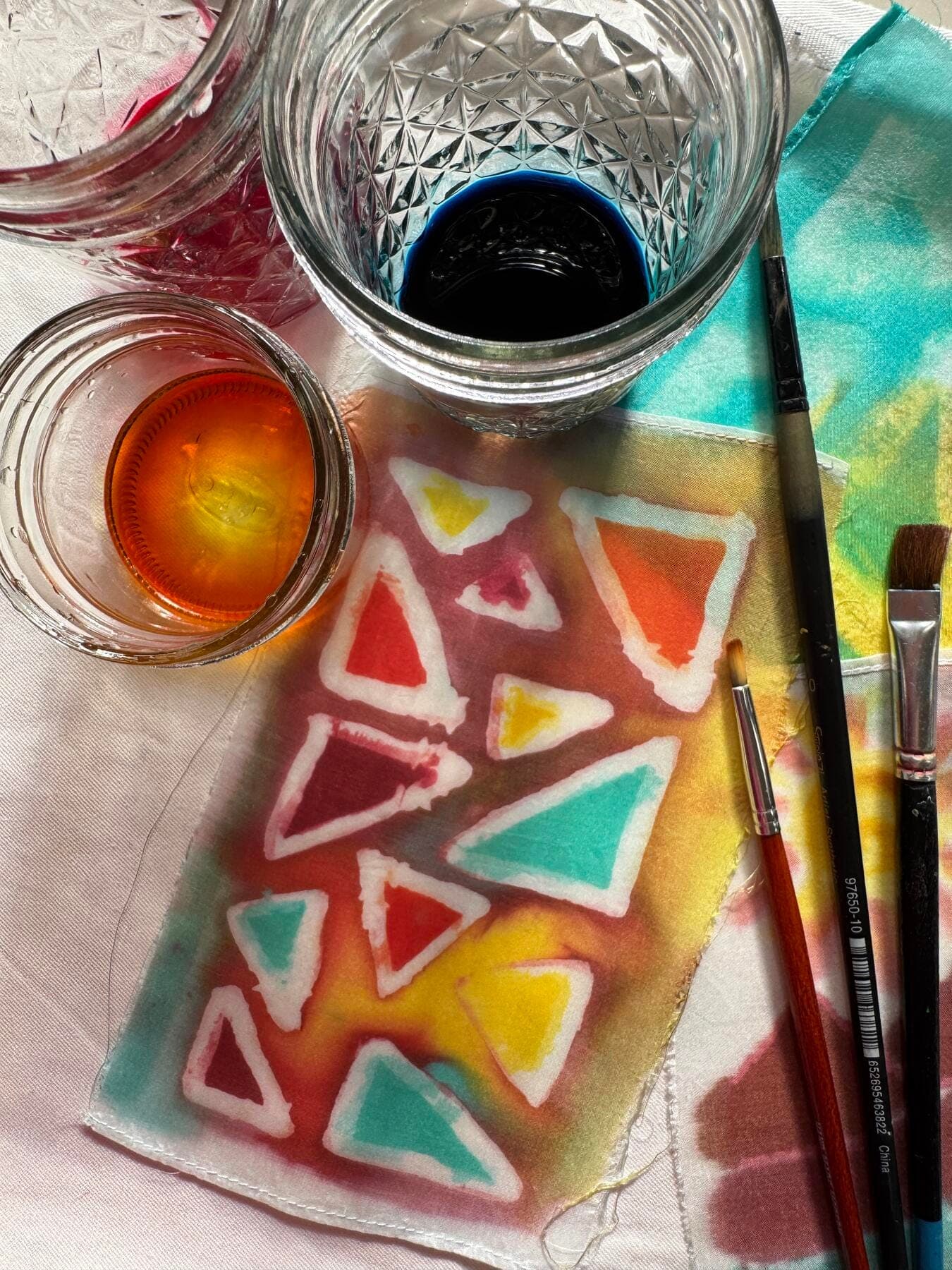 a table with a glass and a cup of liquid on it