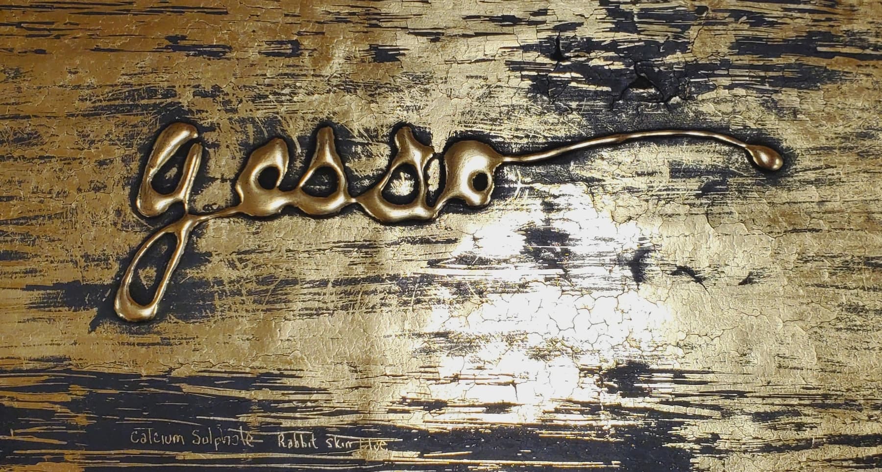 a metal key on a wooden surface