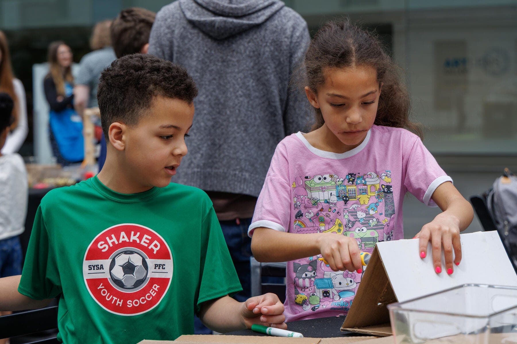 a couple of children looking at a book