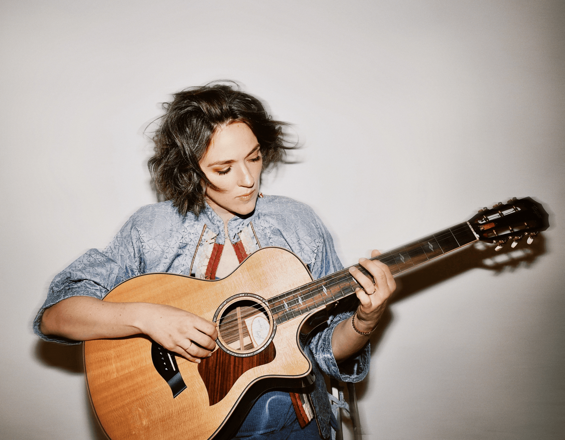 Becca Stevens playing a guitar