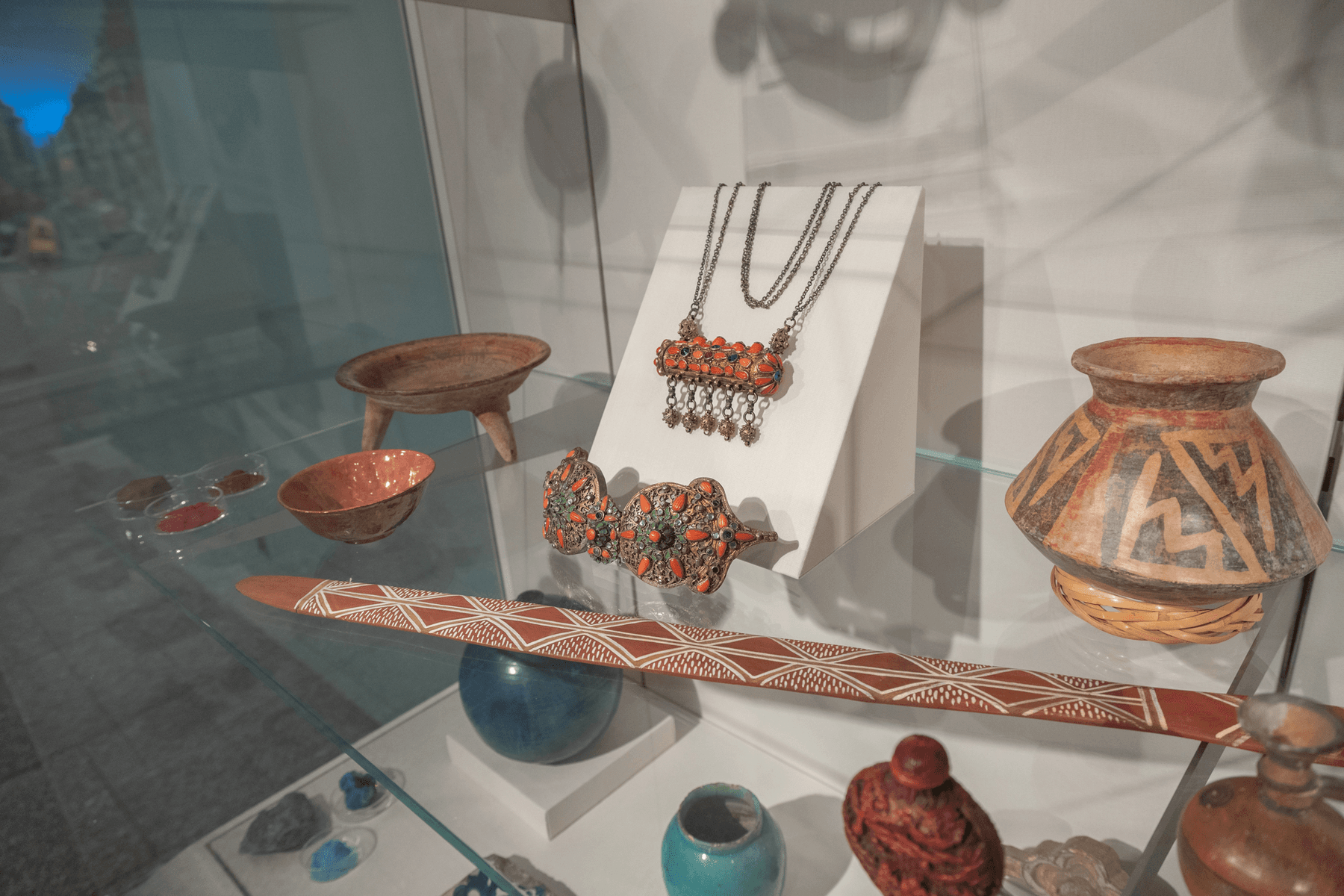 a glass display case with a variety of objects