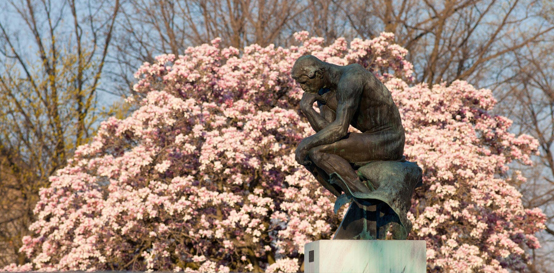 a statue of a person holding a flower
