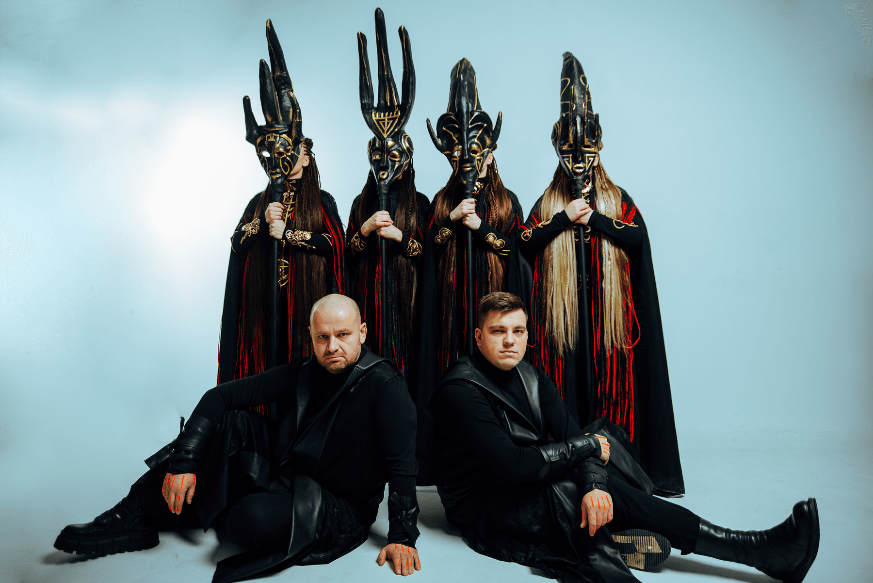 a couple of men in black robes sitting on a throne with swords