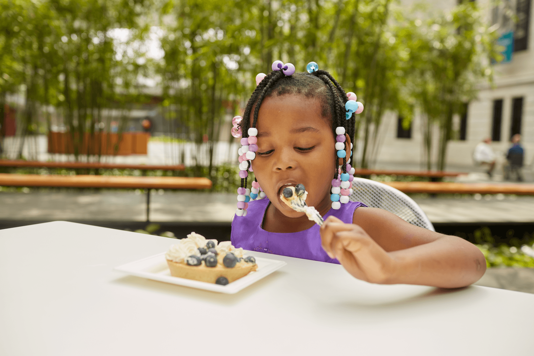 a girl eating a cake