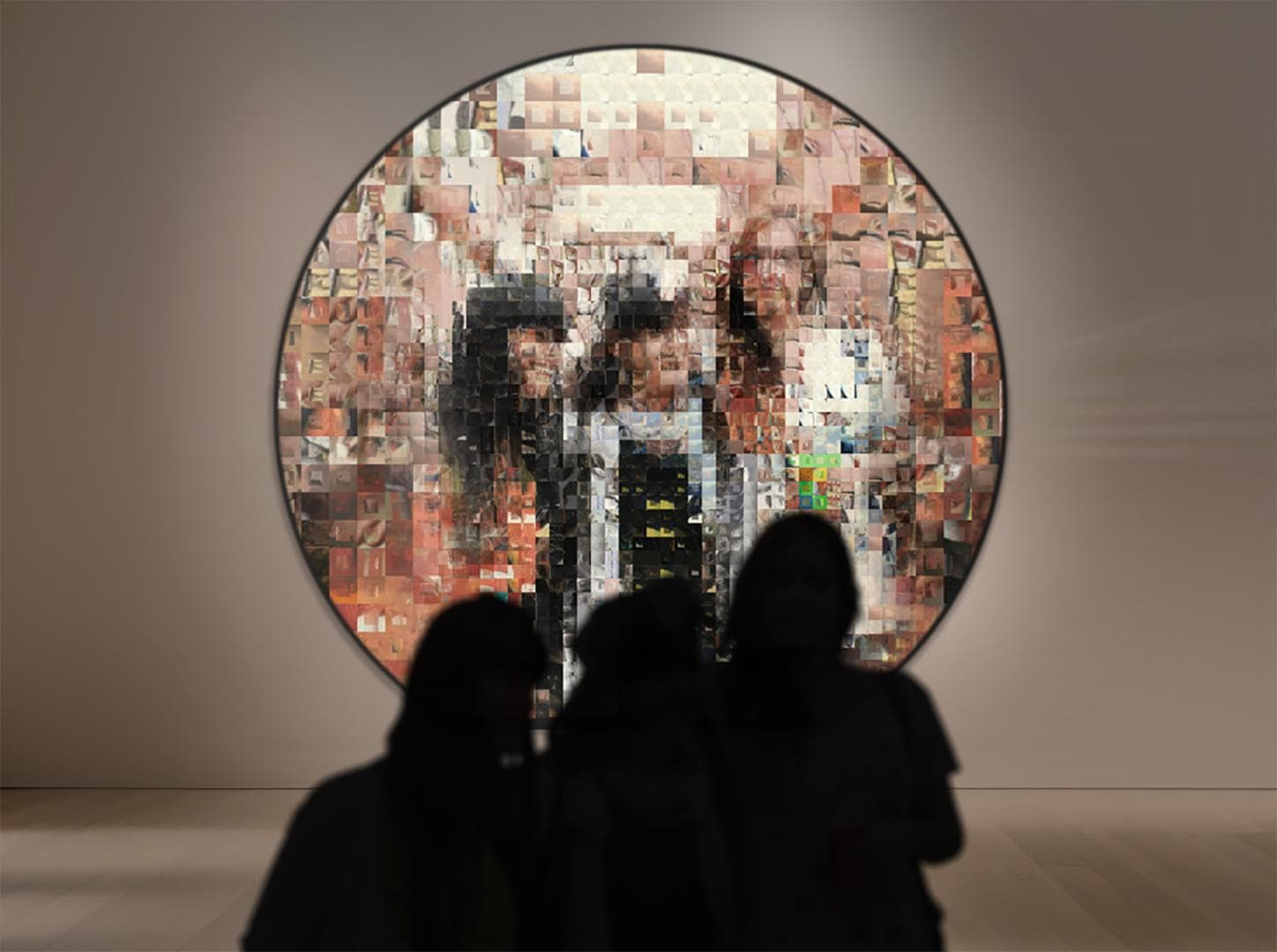 a group of people looking at a large circular mirror