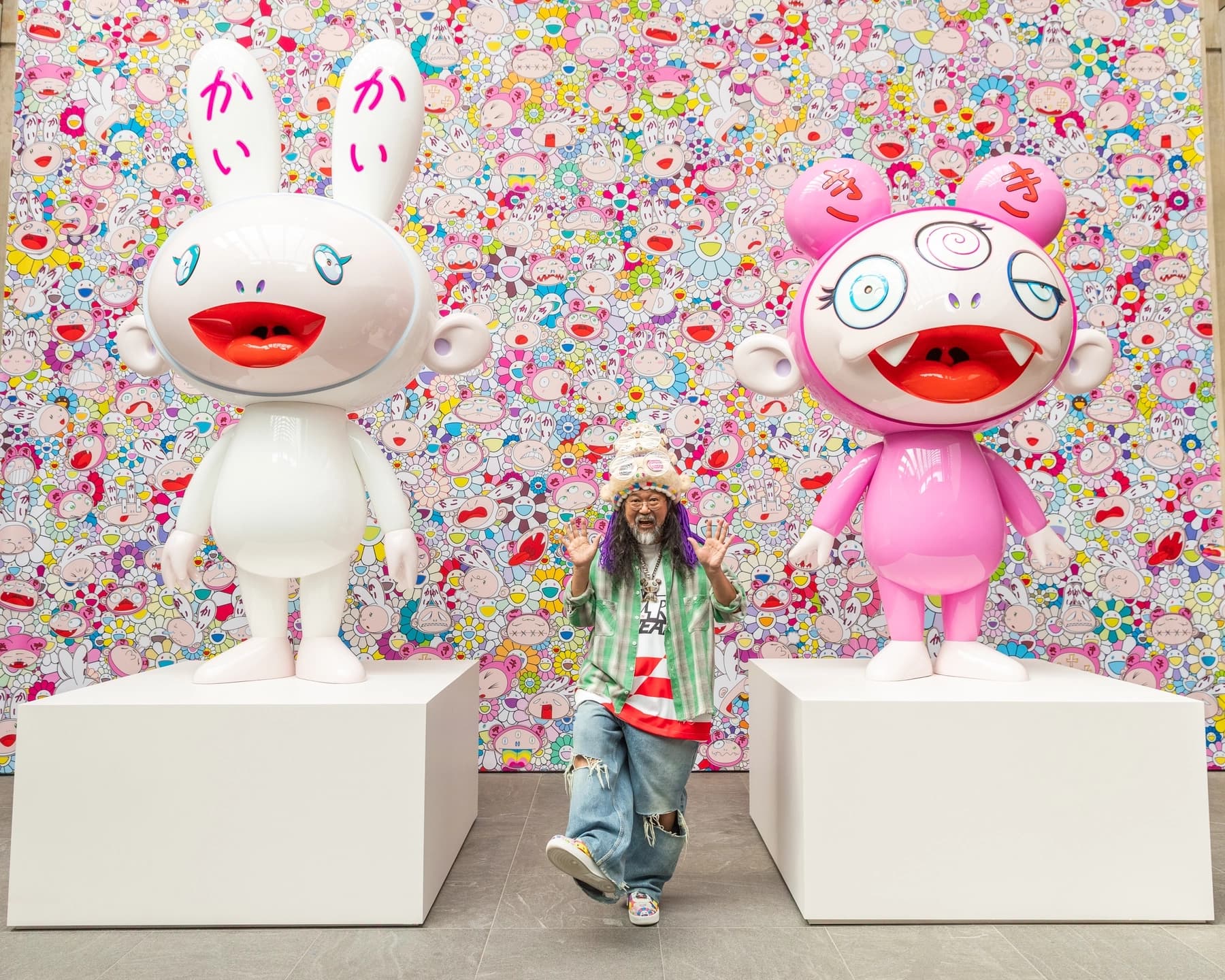 The artist, Takashi Murakami standing between two of his large sculptures.