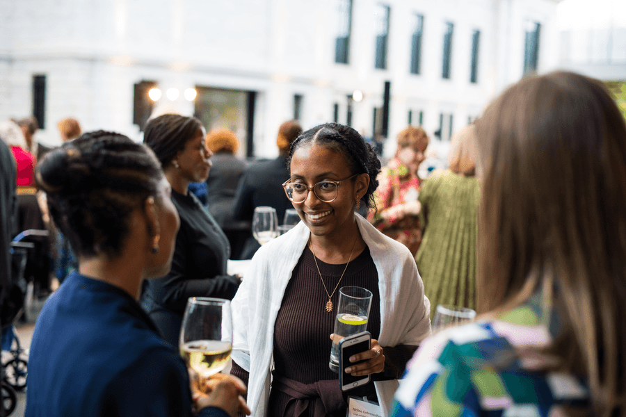 a person holding a glass of beer