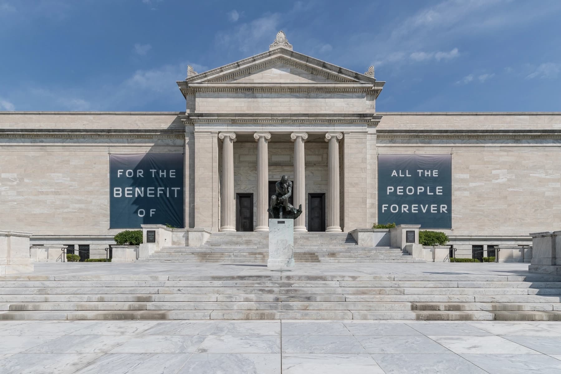 a building with columns and a sign