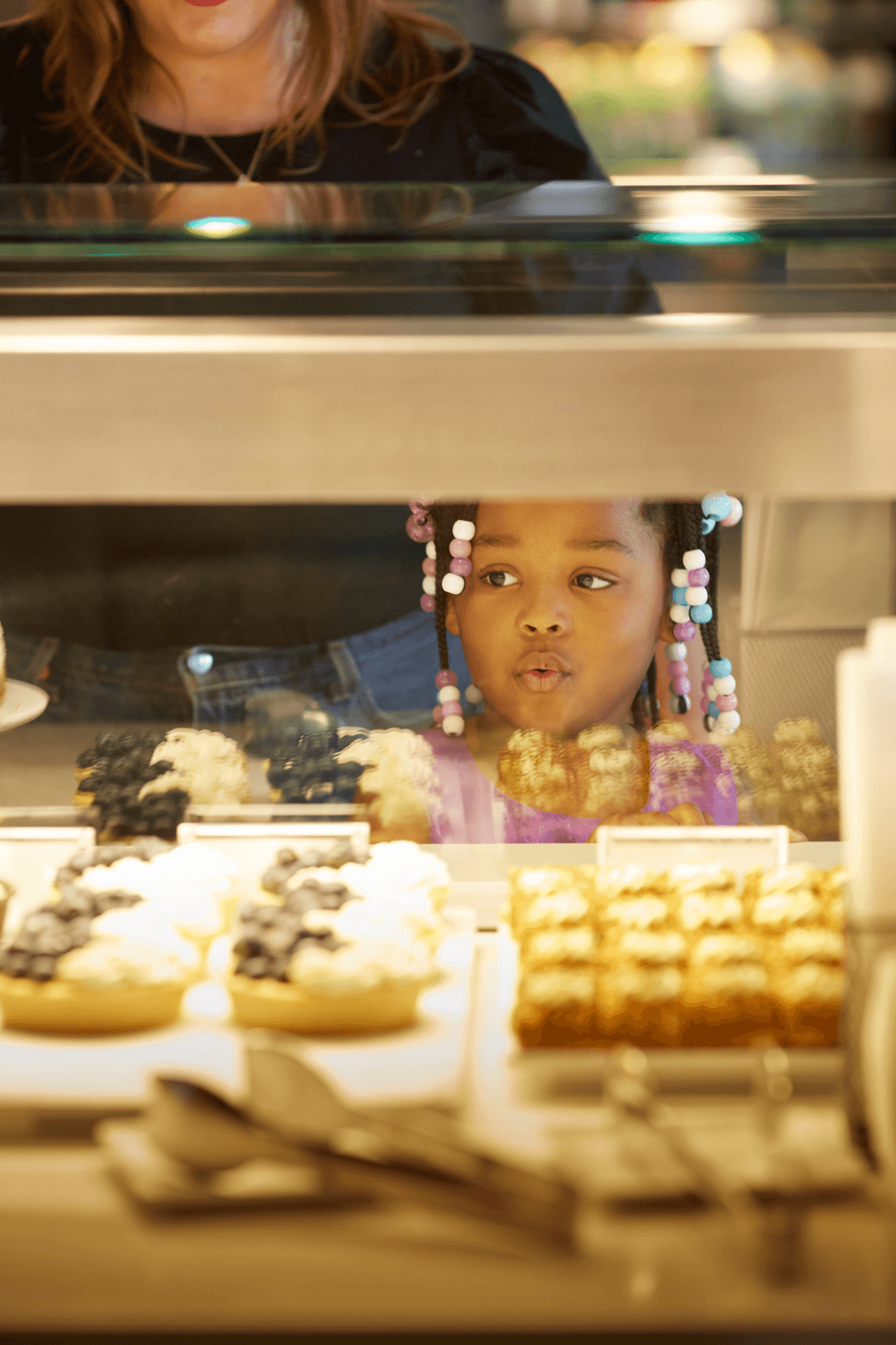 a baby in a box of cupcakes