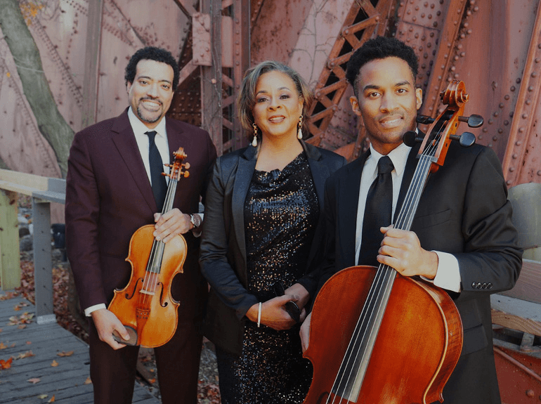 a group of people holding musical instruments