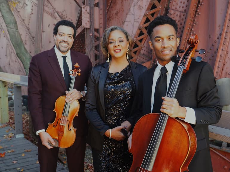 a group of people holding musical instruments