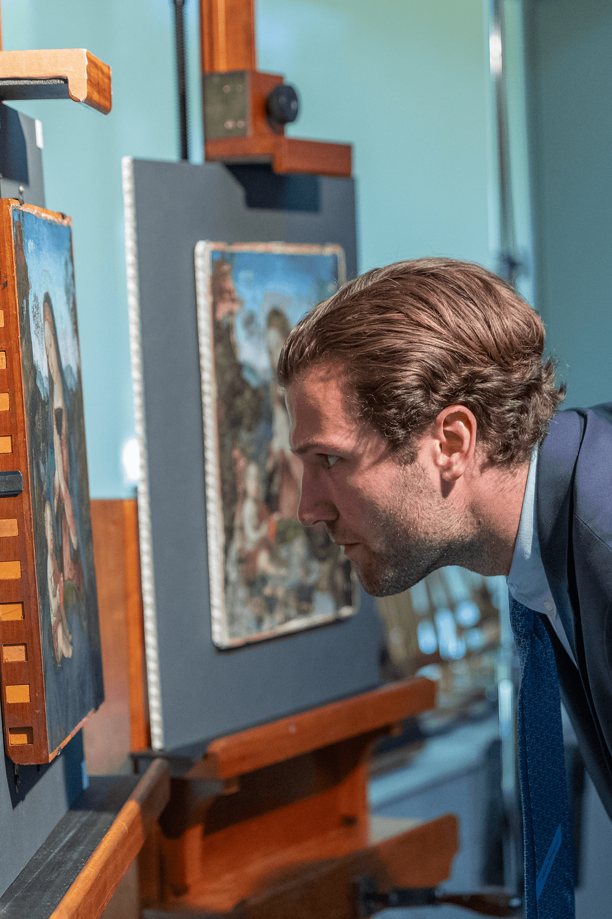 a man looking at a painting