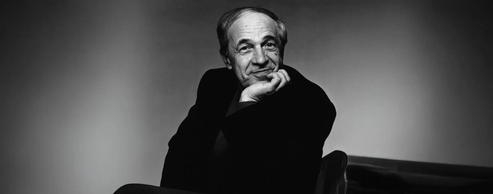 Pierre Boulez sitting in a chair